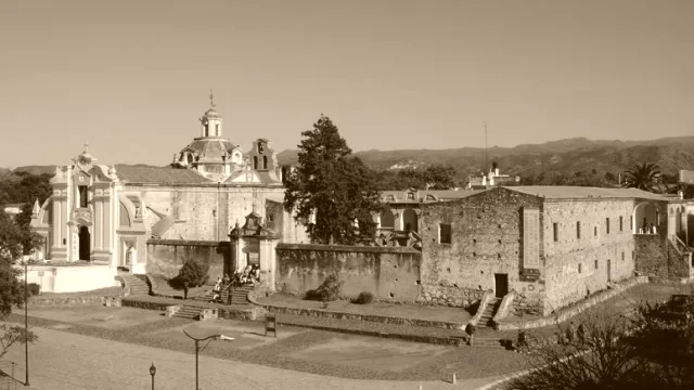 Complejo histórico de la estancia jesuítica con iglesias y muros antiguos en Alta Gracia, Córdoba, en fotografía sepia.