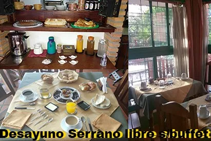 Mesa dispuesta para desayuno con café, jugos, panes, mermeladas y utensilios.